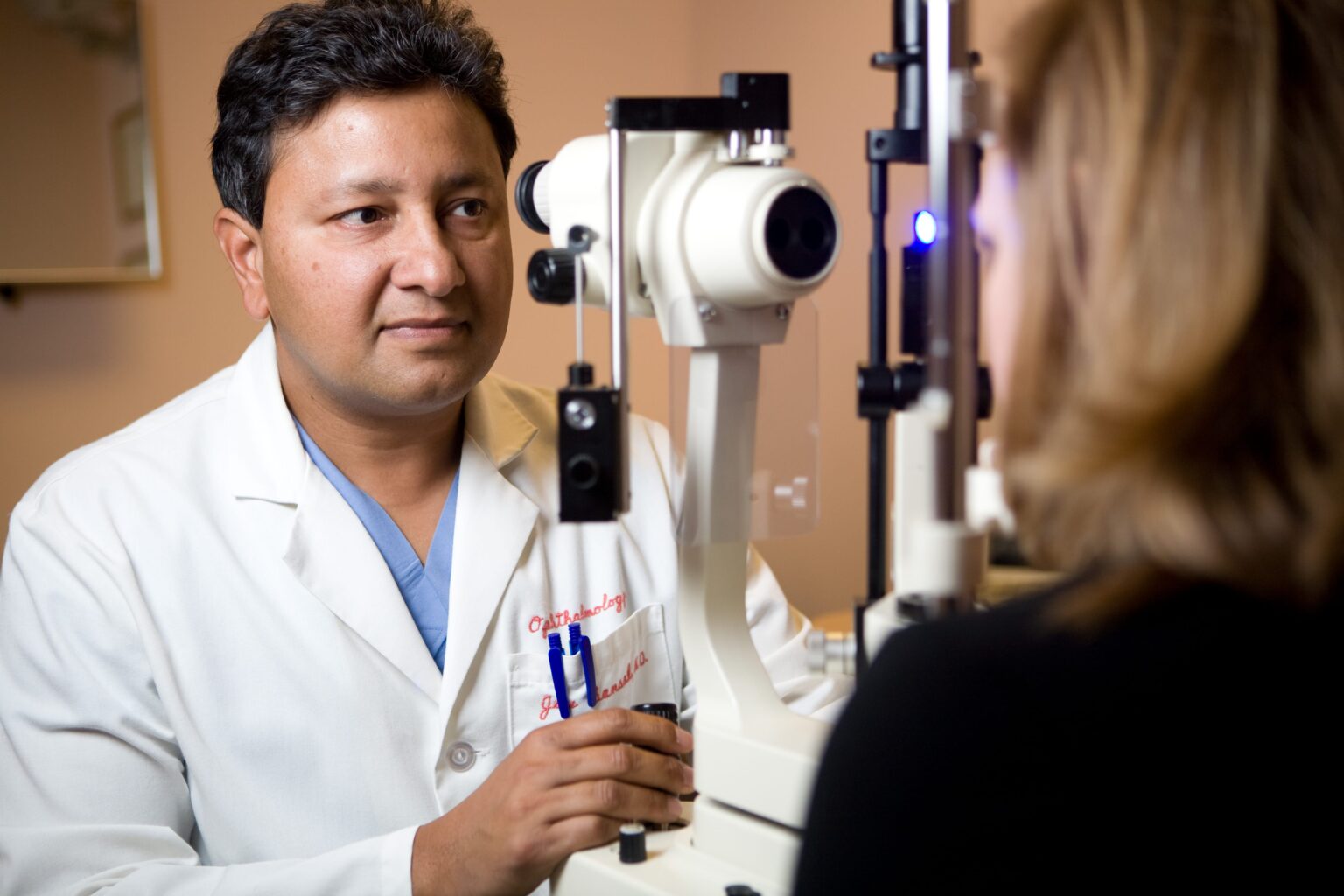 Dr. Jay Bansal performs an eye examination on a patient
