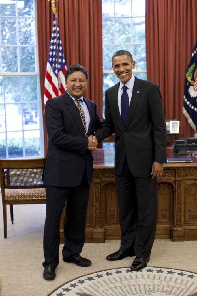 Ophthalmologist Dr. Jay Bansal shaking hands with Former President Barack Obama.