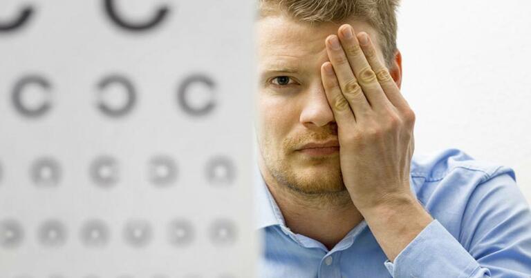 Man Performing Vision Test to determine if he has farsightedness or nearsightedness