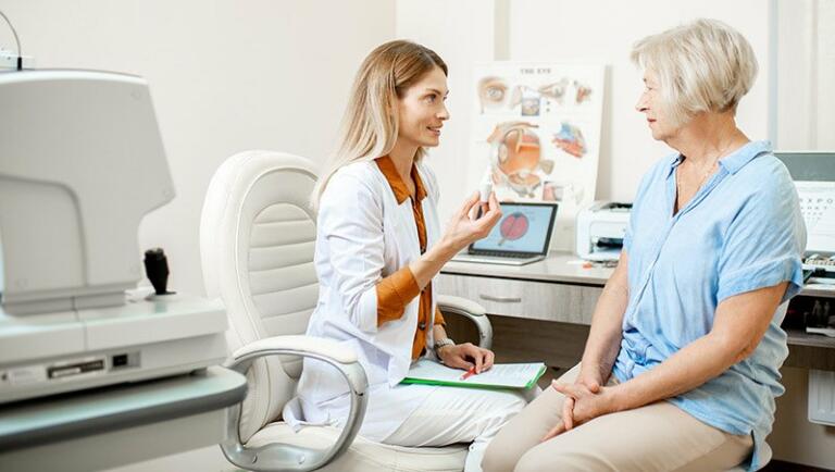 older woman talking to eye surgeon about lasik eye surgery