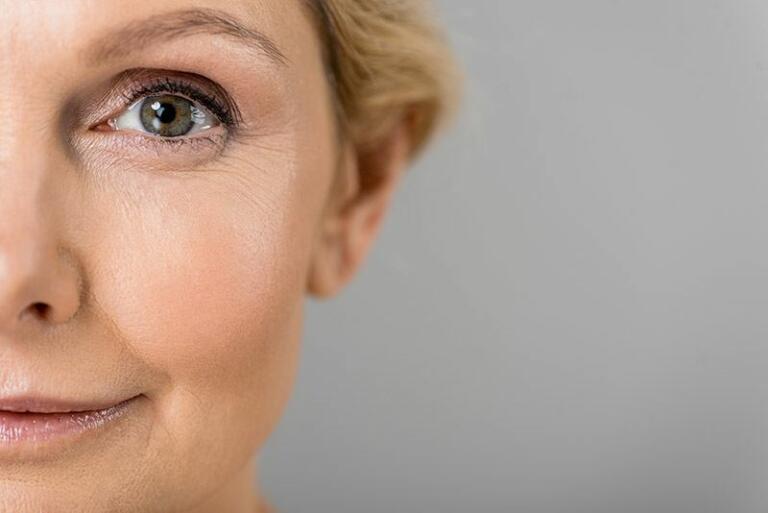 Close up of mature women's face with green eyes