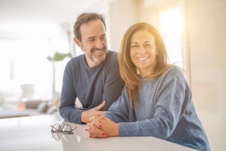 Happy and healthy Middle age couple sitting together at home