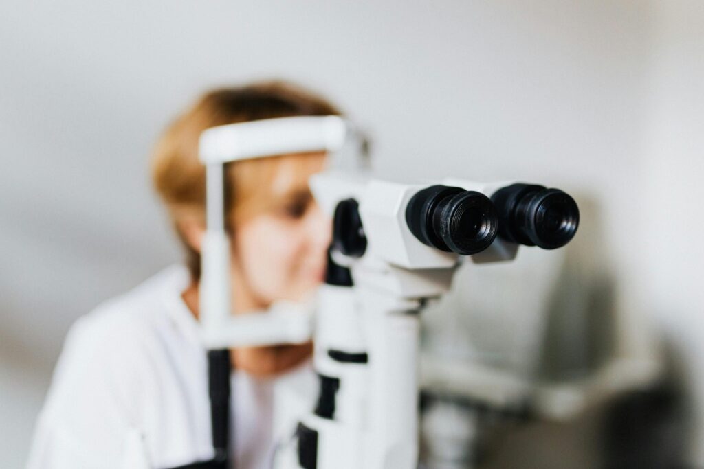 Patient seated at a slit lamp machine