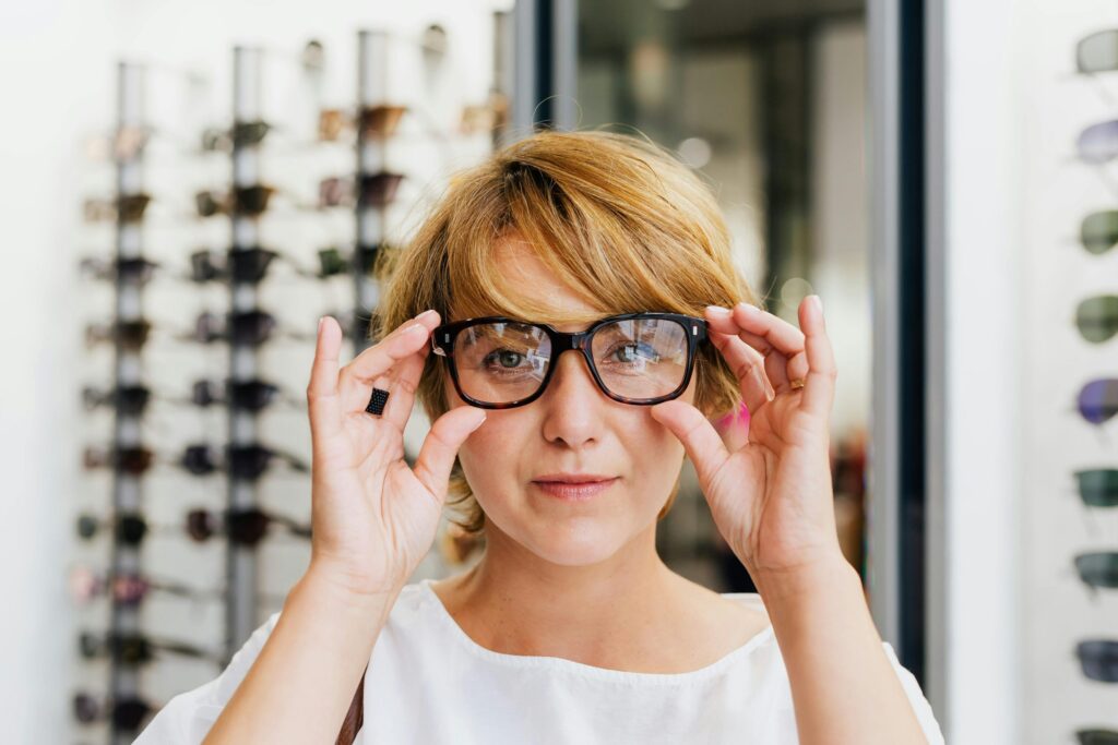 Woman trying on eyeglasses at an optical shop
