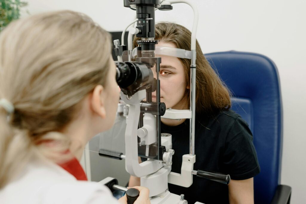 Eye doctor examining a patient at a slit lamp