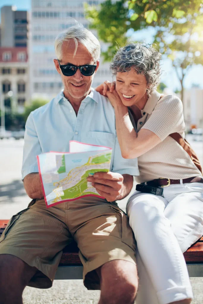 Two older men chatting on a sunny bench