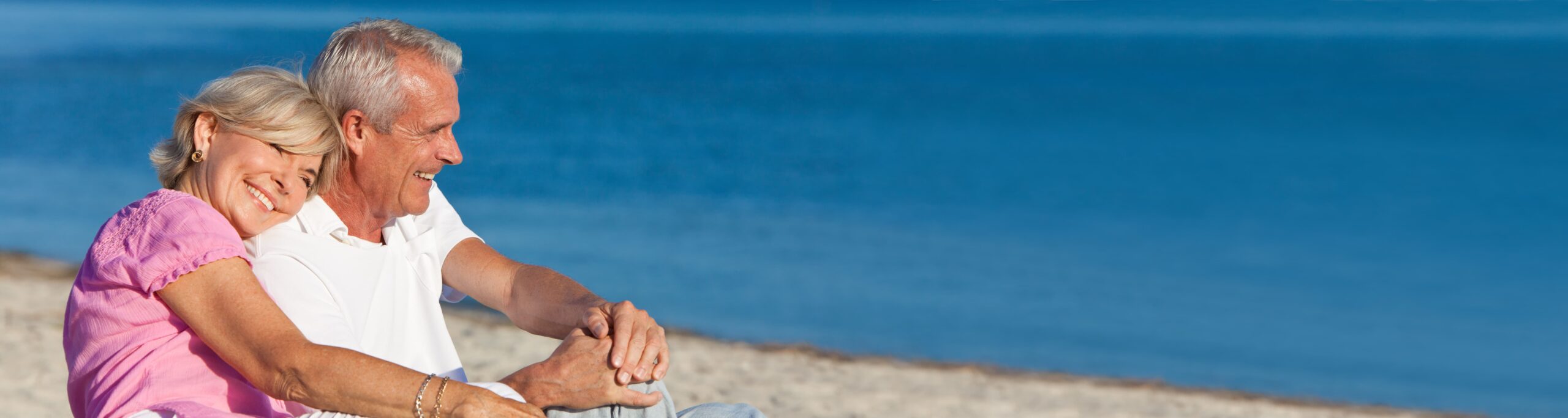 Senior couple happy smiling while sitting on the beach in Northern California and San Francisco