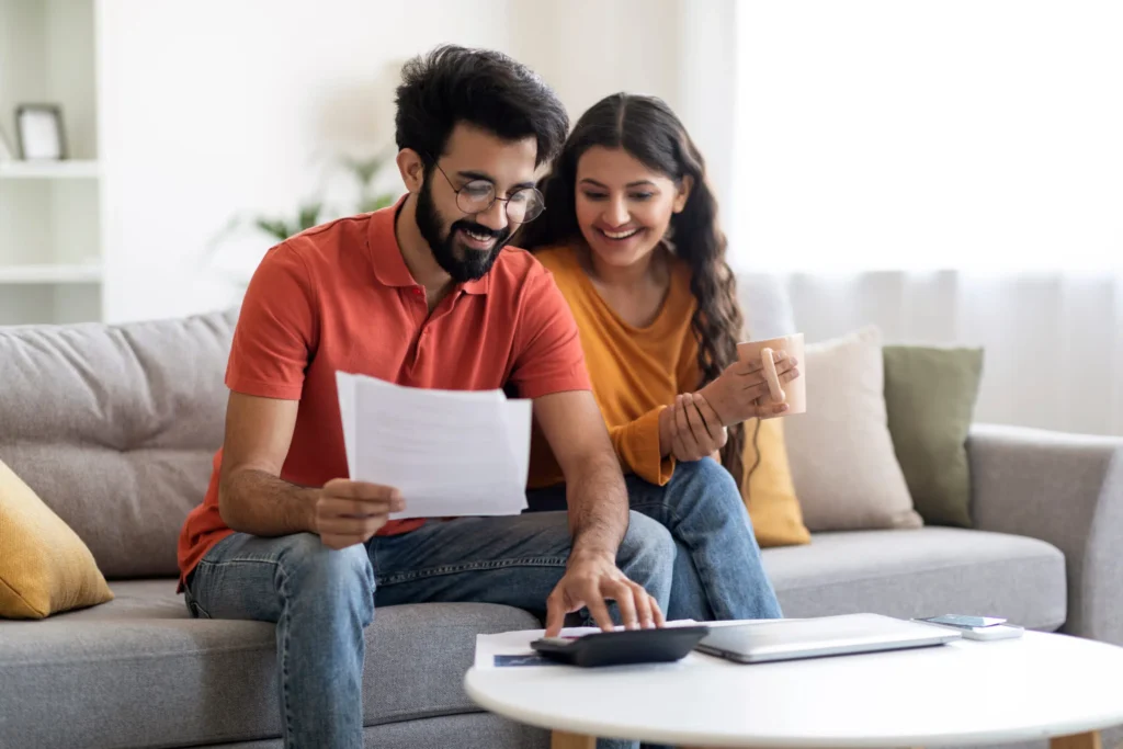 Couple reviewing financing paperwork at home