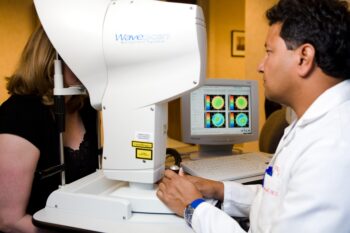 Dr. Jay Bansal performing an eye exam on a patient for laser cataract surgery in the San Francisco Bay Area