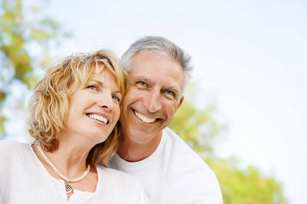 Happy older couple smiling outdoors