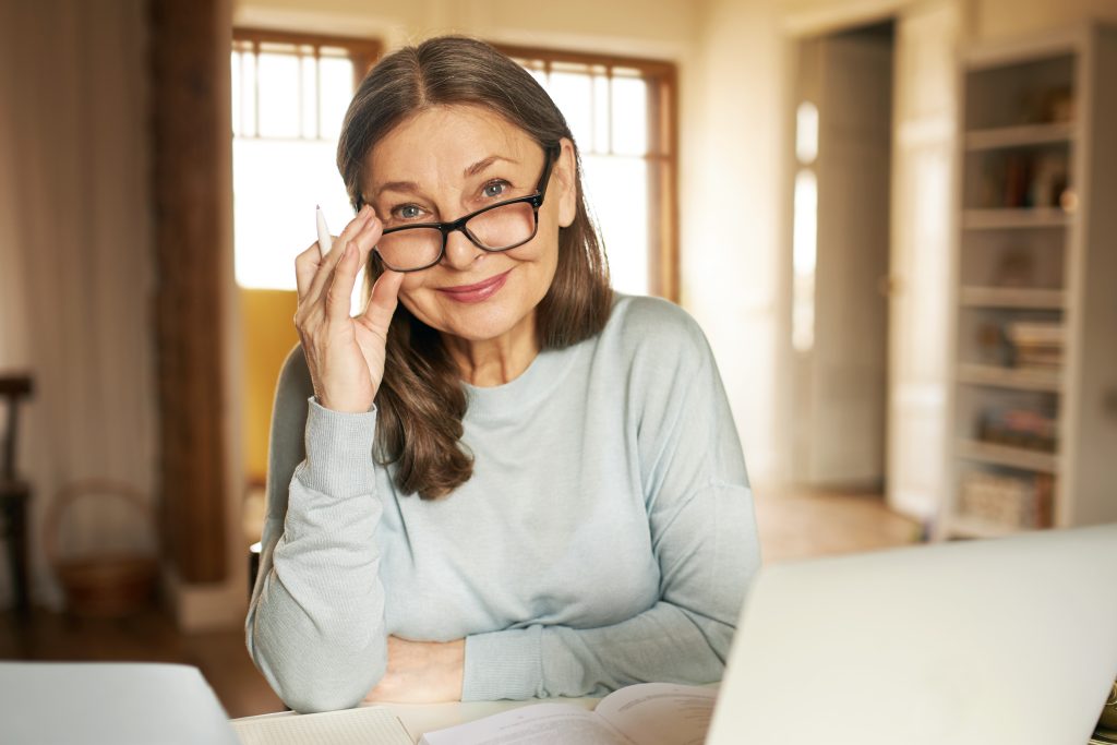 Smiling senior woman wearing glasses indoors