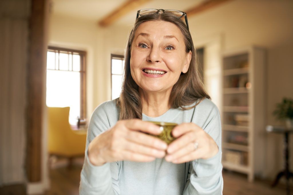 Smiling senior woman with glasses pushed up on her head