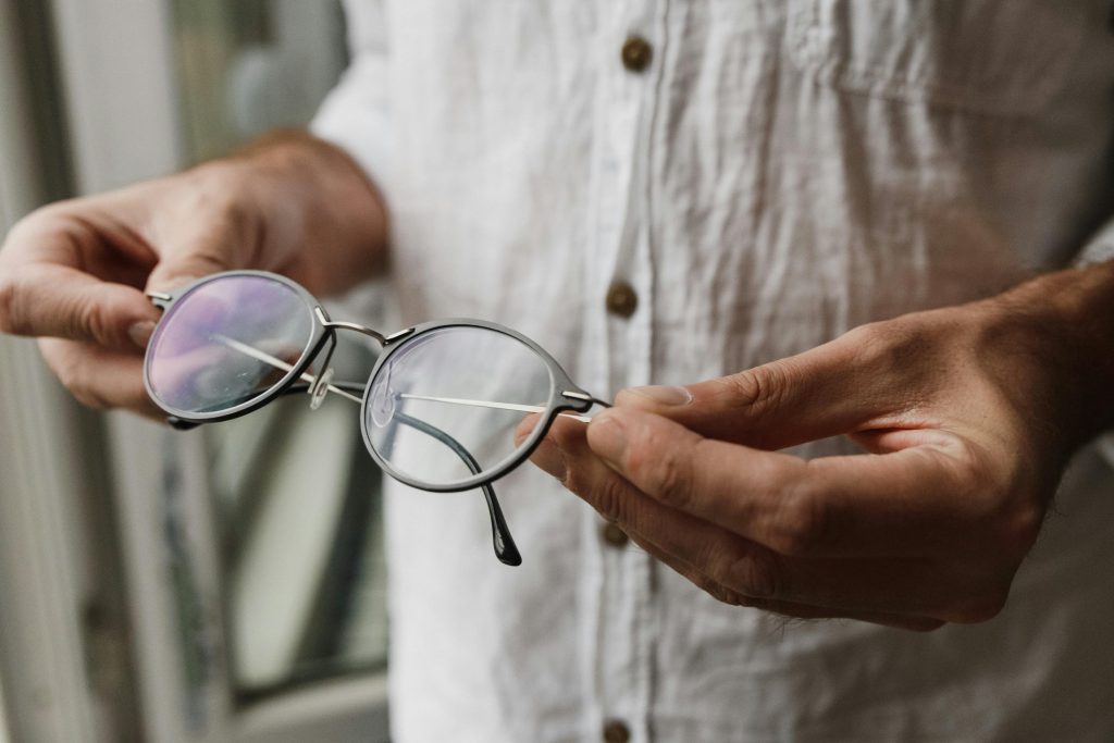 Man inspecting his reading glasses