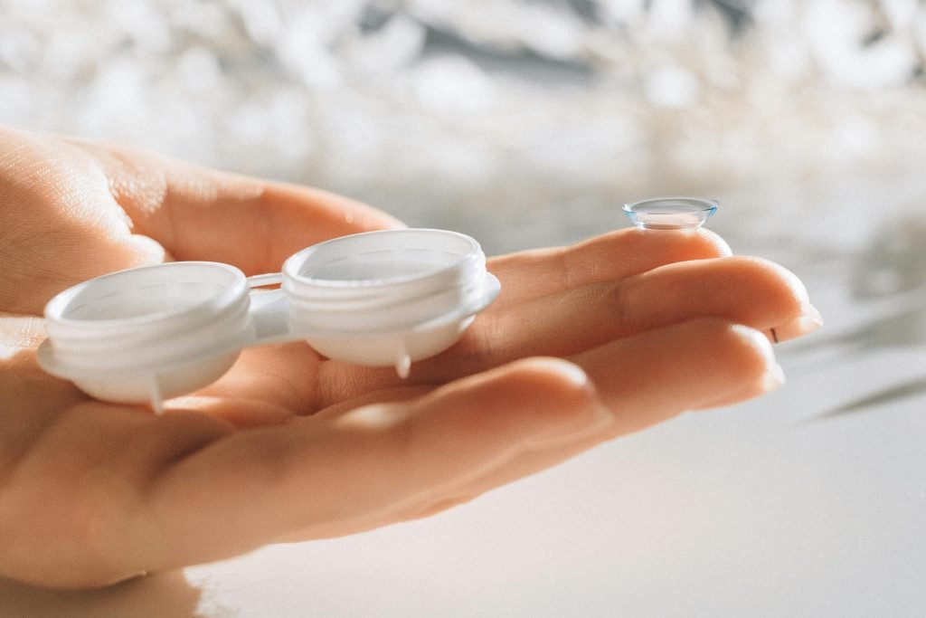 Hand holding an open contact lens case