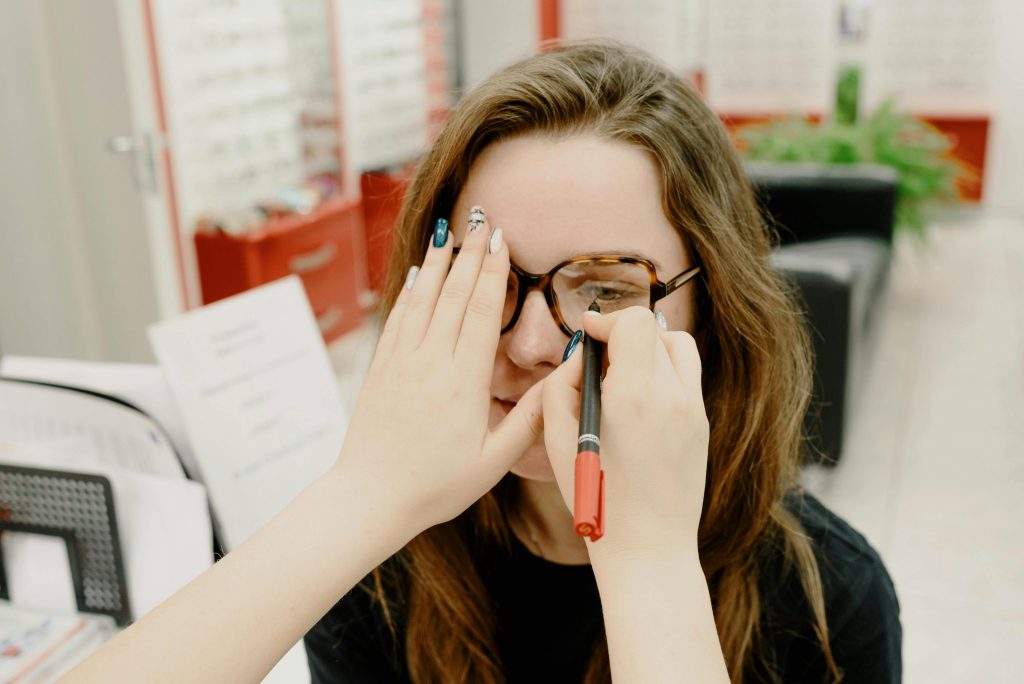 Woman covering one eye during a vision test