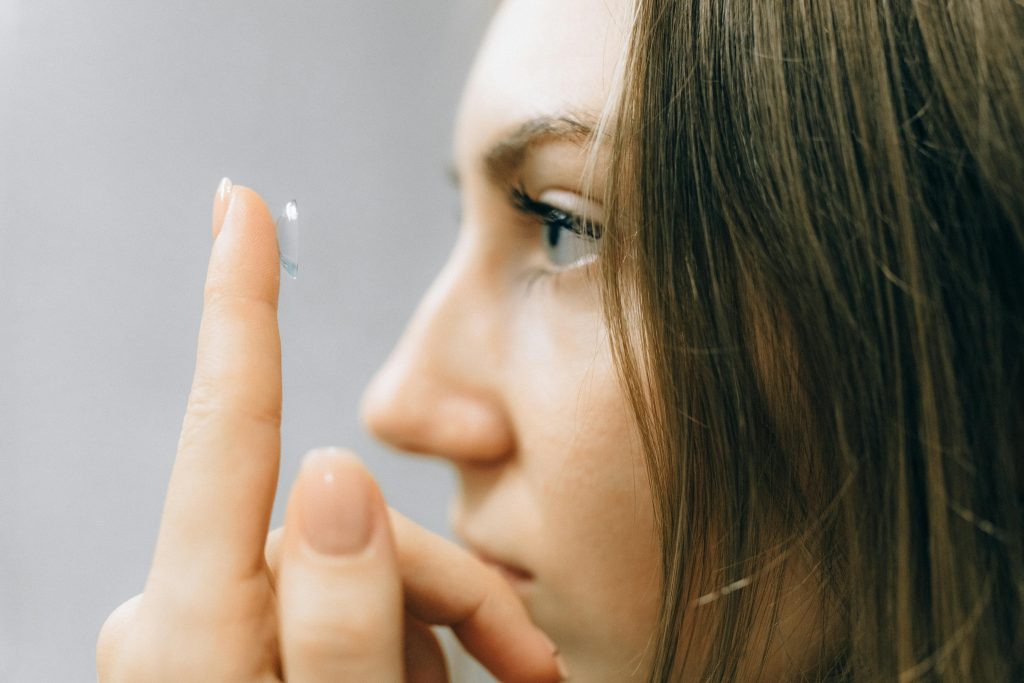 Woman inserting a contact lens