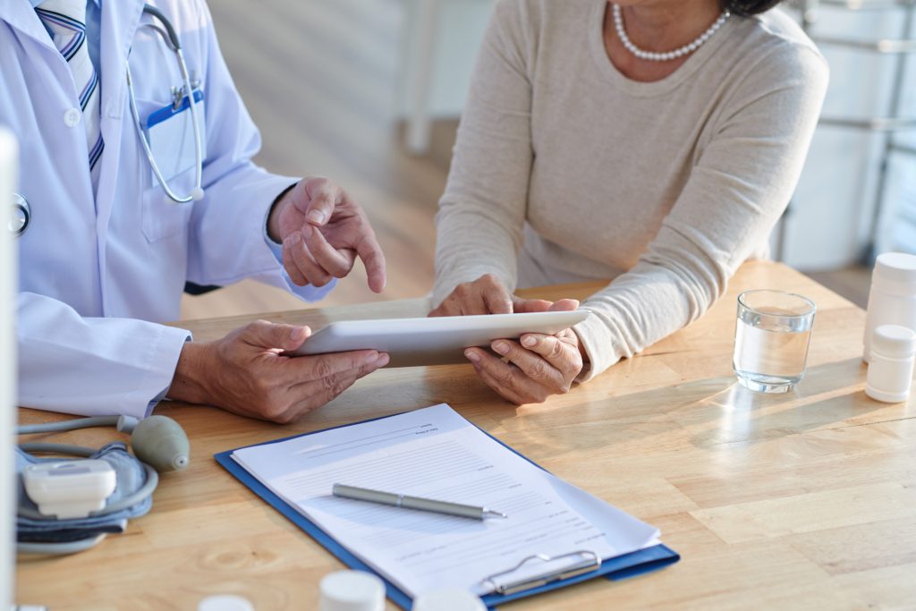 Doctor reviewing paperwork with a patient at a desk