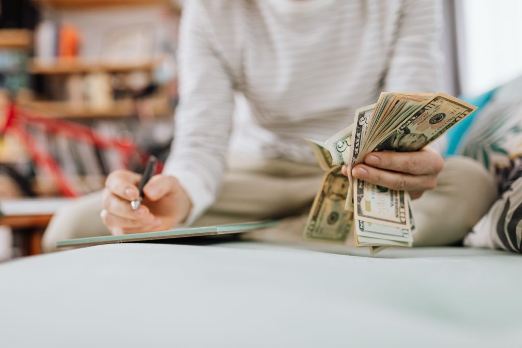 Person counting cash at a desk