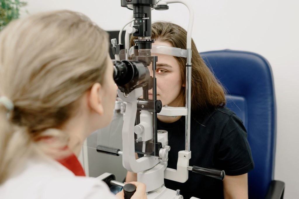 Young woman receiving a slit lamp eye examination