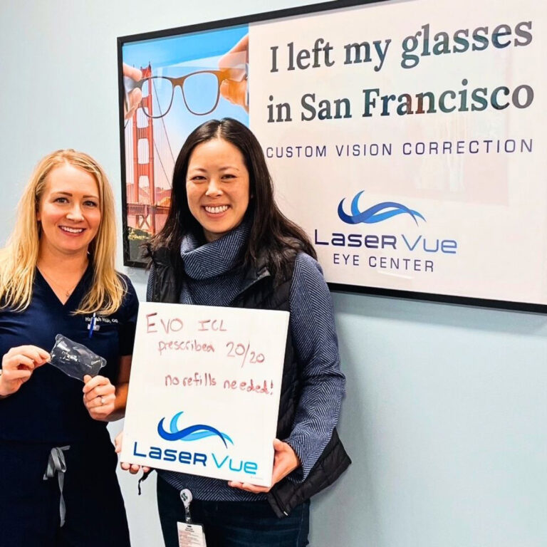Dr. Nicole Luu, PharmD, BCPS, stands with Dr. Hannah Walsh, optometrist at LaserVue Eye Center. Dr. Luu is holding a whiteboard that reads "Prescribed EVO ICL, 20/20, no refills needed! LaserVue." Dr. Luu and Dr. Walsh are standing in front of a poster that reads "I left my glasses in San Francisco. Custom Vision Correction. LaserVue Eye Center."