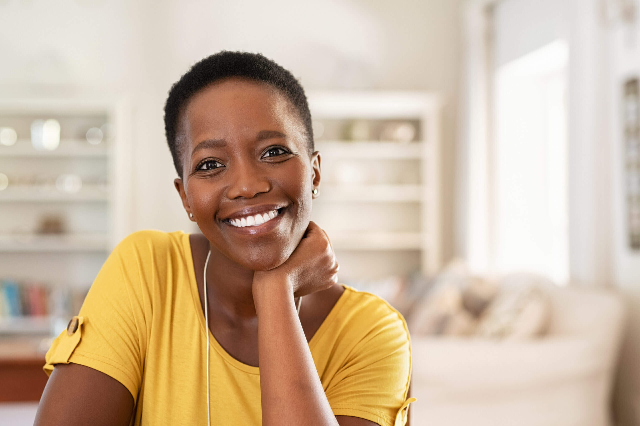 Portrait of mature woman sitting at home and looking at camera.