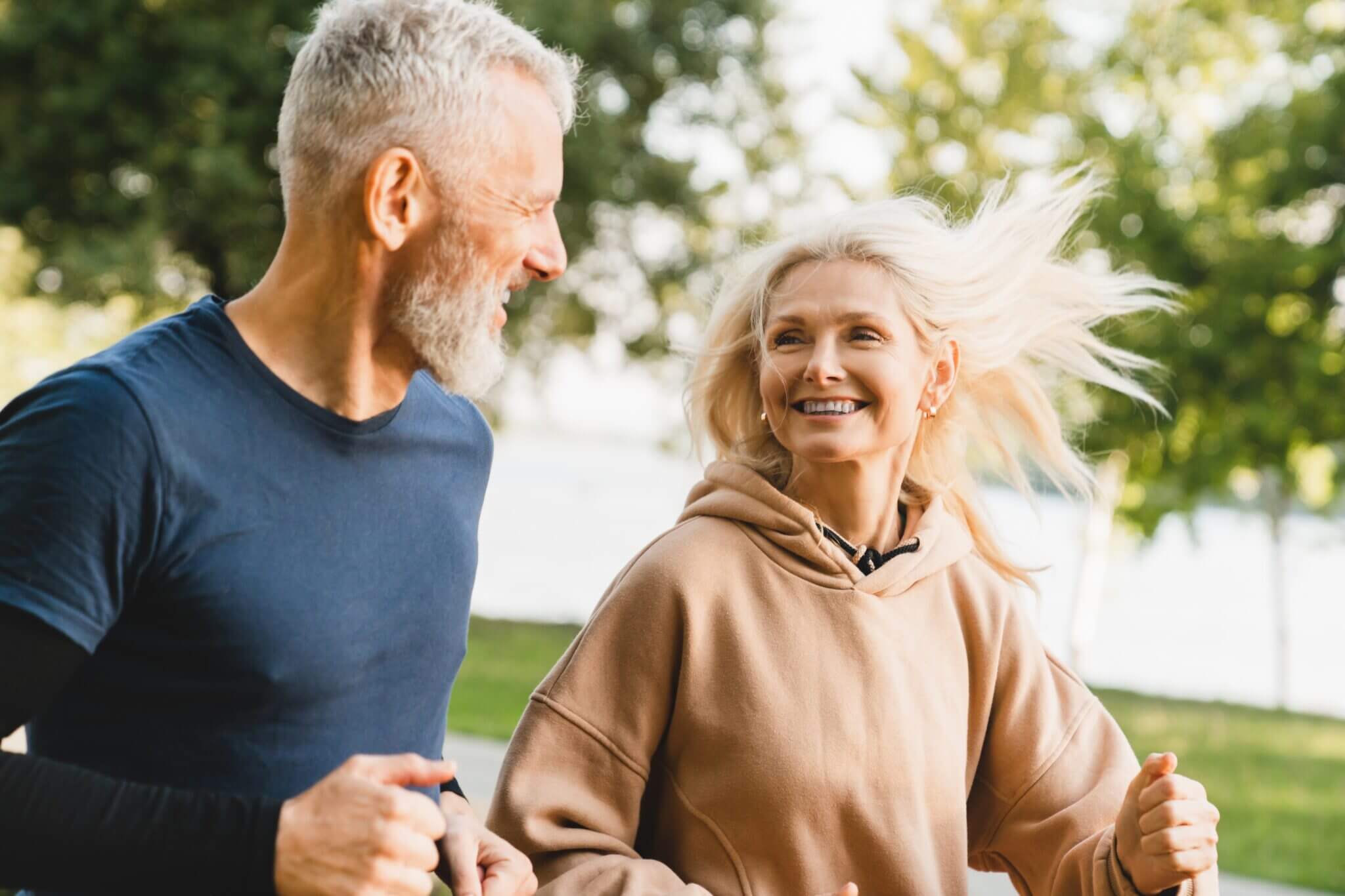 Happy active couple exercising in a park